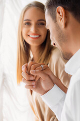 Close-up of engagement ring — couple holding hands with love