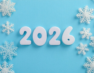 Numbers 2026 with snowflakes celebrating New Year on a blue background