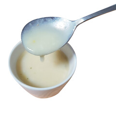 A curated collection of wholesome and savory cream soup with a spoon in a bowl.

