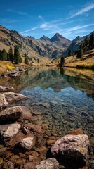 Fototapeta premium Serene alpine lake reflecting mountains. Crystal-clear water reflects peaks and autumnal hillside. Rocky shoreline