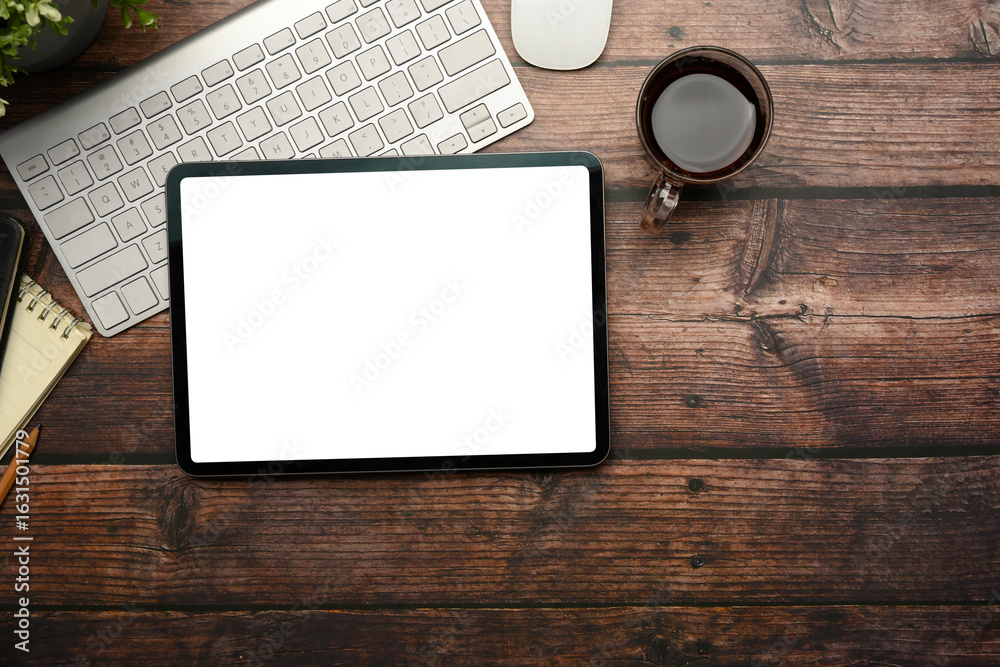 Wall mural top view of digital tablet with blank screen on rustic wooden table