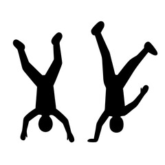 Two people doing handstands silhouette