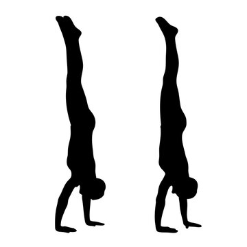 Two gymnasts performing handstands silhouette