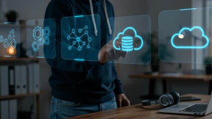 Man managing cloud computing and digital data networks with a futuristic holographic interface in a modern office setting. - Powered by Adobe