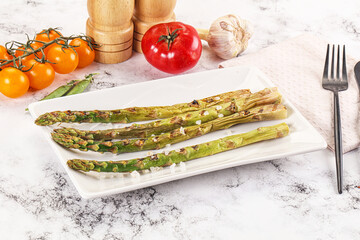 Grilled asparagus sprouts served red pepper