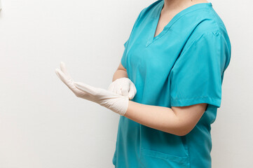Nurse putting on medical gloves for procedure