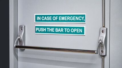 Panic bar door handle on emergency fire exit door in public building