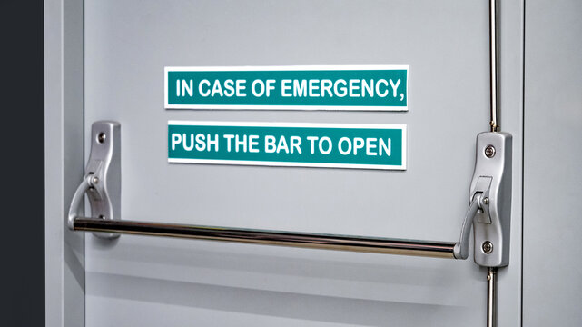 Panic bar door handle on emergency fire exit door in public building