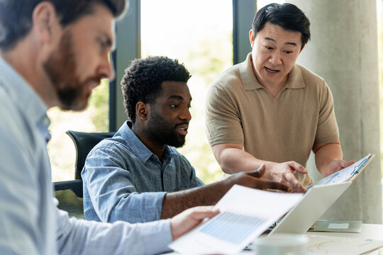 Diverse team analyzing financial data in modern office