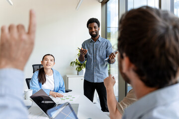 Manager presenting new project to colleagues during office meeting