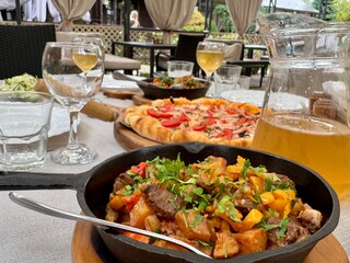 Pizza and wine on the table in a restaurant