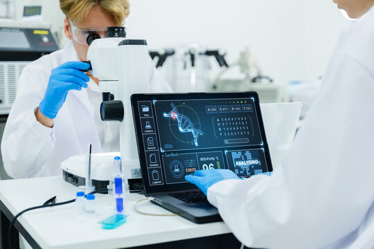 Scientists analyzing DNA data in high-tech lab.