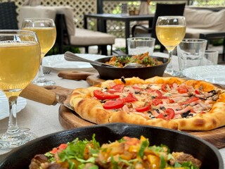 Pizza and wine on the table in a restaurant