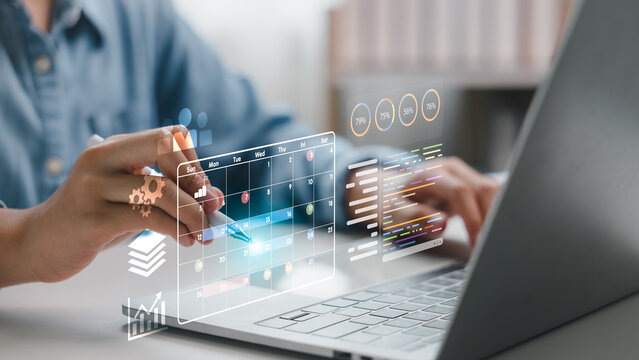 Businessman using a digital calendar and data dashboard on laptop for project planning, time management, and performance tracking, concept for productivity, workflow, and smart work.