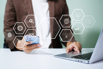 Businessman using mobile with virtual AI, cloud, data, and teamwork icons—illustrating digital transformation, global tech, and innovation in workplace.