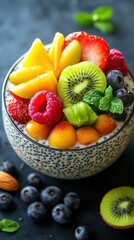 Colorful fruit bowl with chia seeds and nuts on a dark background