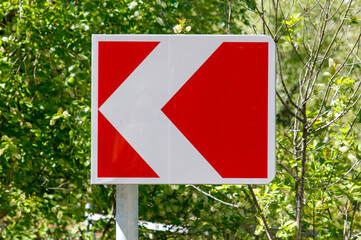 A red and white sign with a white arrow pointing to the right