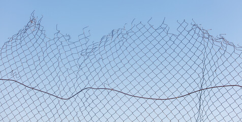 A fence with a broken chain link