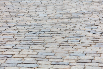 A close up of a brick pavement with a grey and white color scheme