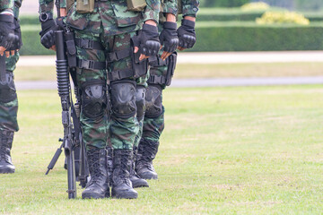 A row of soldiers in camouflage uniforms standing in formation. Represents military discipline, national defense, and armed forces.