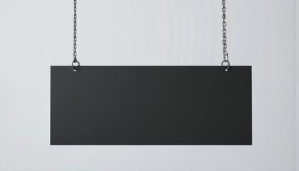 Blank black rectangular sign hangs by metal chains against minimalist grey studio wall. Empty sign template offers ample copy space for advertising, branding, displaying messages. Features clean,