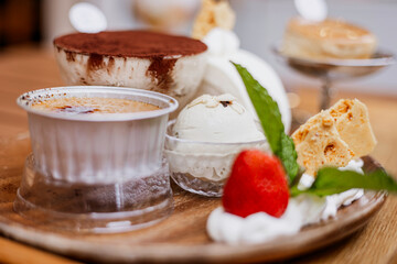 chocolate dessert with strawberry ice-cream and cream, tiramisu with cocoa powder, mint leaf, toufu cake roll, biscuit and creme brulee, cafe dessert meun for afternoon tea