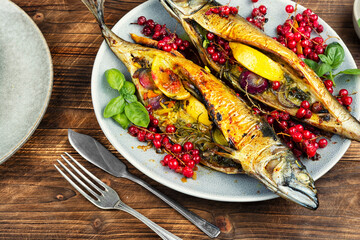 Fried or baked mackerel fish with berries.