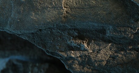 Close-up of eroded rock surface with vertical streaks and rough textures