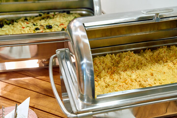 A Assortment of Flavorful Rice Dishes Displayed in Elegant Buffet Trays Ready for Dining in a...