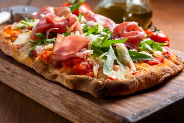 Pinsa romana con rucola, parmigiano e prosciutto crudo, cibo italiano 