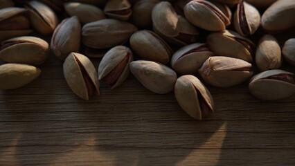 Pistachio nuts with light and shadow interplay on surface
