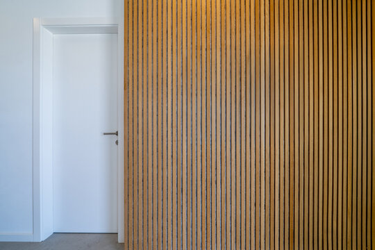 Sound dampening acoustical panels detail of a wooden wall and white door