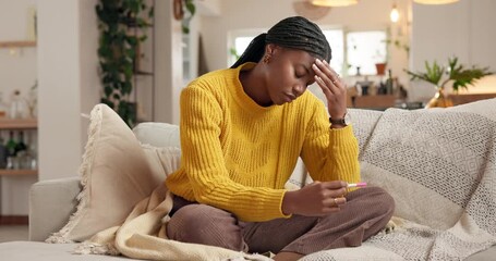 Black woman, headache or stress with maternity test on sofa for unplanned pregnancy or mistake. Female person, anxiety or depression with pregnant stick or kit for medical result or screening in home
