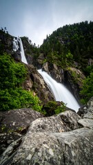 Fototapeta premium Majestic waterfall cascading down rocky cliffs (1)