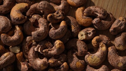 Top view of raw cashew nuts on wooden surface