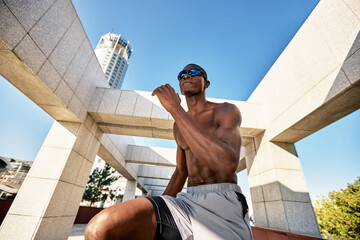 Athletic man in an urban setting engaging in outdoor fitness training