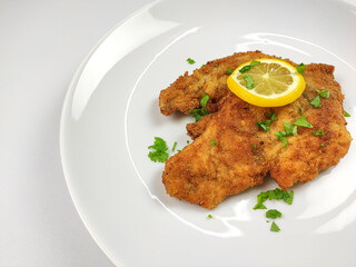 German Chicken Schnitzel close up shot in a white plate