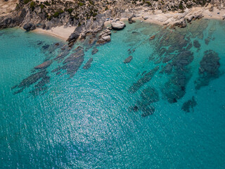 Aerial view of rocky coastline with turquoise water and pine forest in Greece. Stunning seascape...