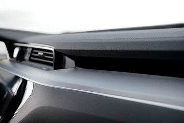 Interior of a premium electric SUV, black leather, aluminum, decorative elements.