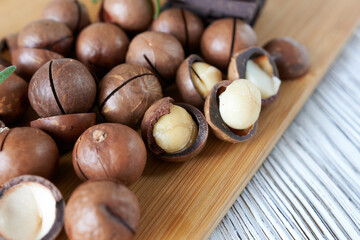 Macadamia nuts on a wooden background. Macadamia is a healthy nut.
