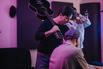 Three musicians are engaging in a collaborative music session inside a recording studio. They are surrounded by guitars and studio equipment, showcasing a creative atmosphere filled with teamwork.