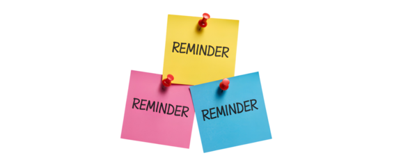 Three colorful sticky notes with the word Reminder written on them pinned with red thumbtacks
