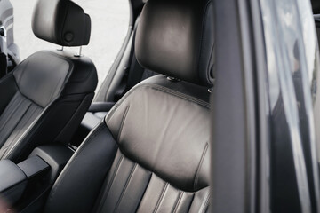 Interior of a premium electric SUV, black leather, aluminum, decorative elements.