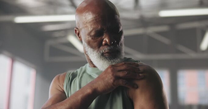 Exercise, injury and shoulder pain with black man in gym for accident, cramp or muscle fatigue. Fitness, stress or training and mature athlete in health club with fibromyalgia or medical condition