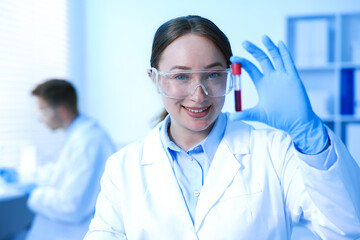 Naklejka premium Medical analysis. Scientist working with blood sample in laboratory, selective focus