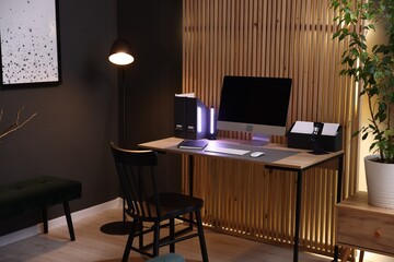 Stylish workplace with wooden desk, computer and chair indoors