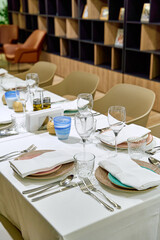 Elegant Dining Setup Showcasing a Tastefully Arranged Table with Fine Dishware, Glassware, and Centered Decorative Elements for a Memorable Culinary Experience