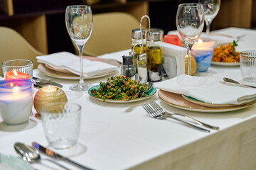 Elegant Dining Experience with a Delightful Spread of Gourmet Dishes and a Cozy Atmosphere Enhanced by Candlelight and Fine Table Settings