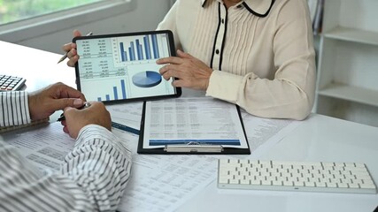 accountant team review accounts report and using digital accounting program software on digital tablet for working accounting standards system at office.	 - Powered by Adobe