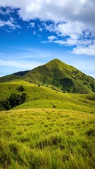 Lush green mountain landscape under a vibrant sky